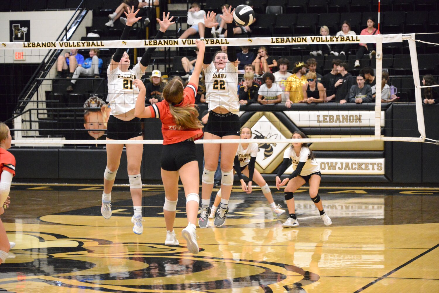 Kaidynce Buttram and Saylor Helton put up a wall of hands to stop the volleyball from entering 'Jacket territory.